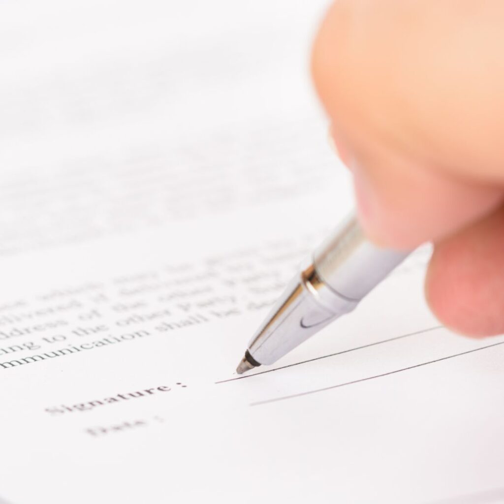 a person signing paperwork