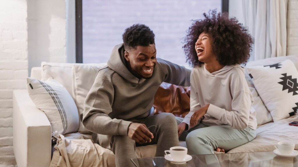 couple laughing and relaxing on a couch