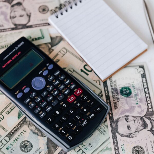 calculator, cash and a note pad