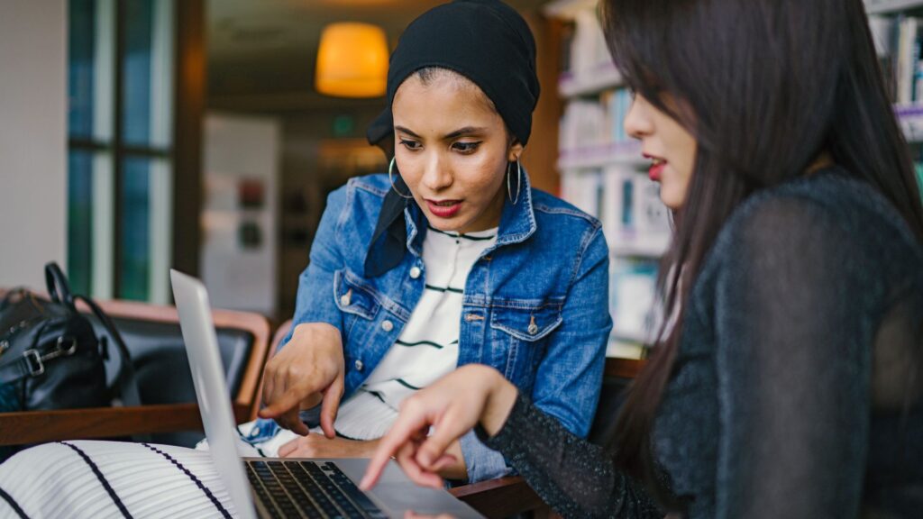 two women looking at laptop